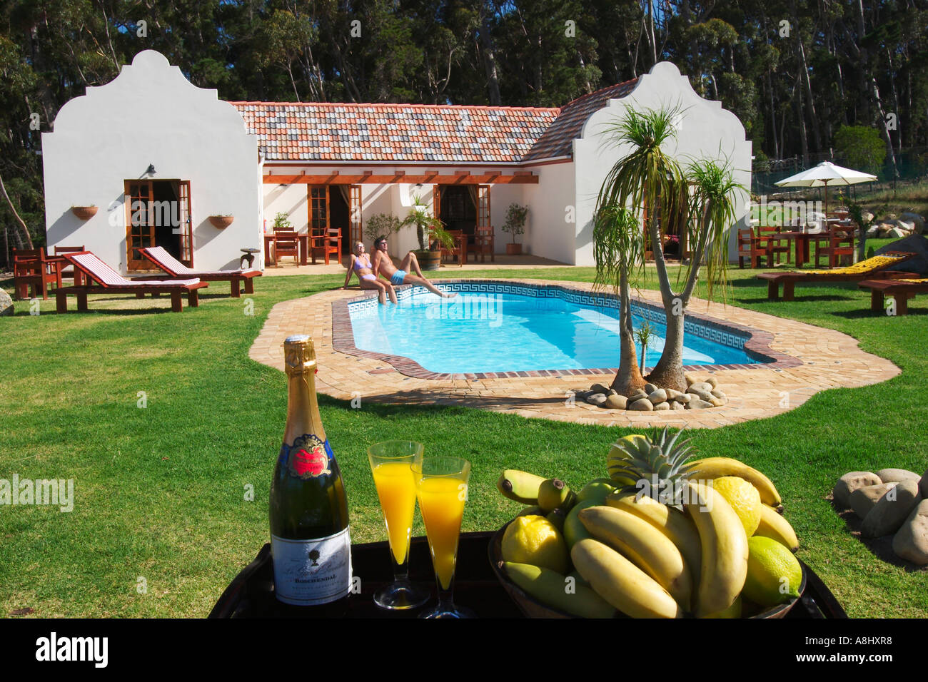 Seven Heaven Lodge in Somerset West in South Africa with cople at the  swimming pool Stock Photo - Alamy