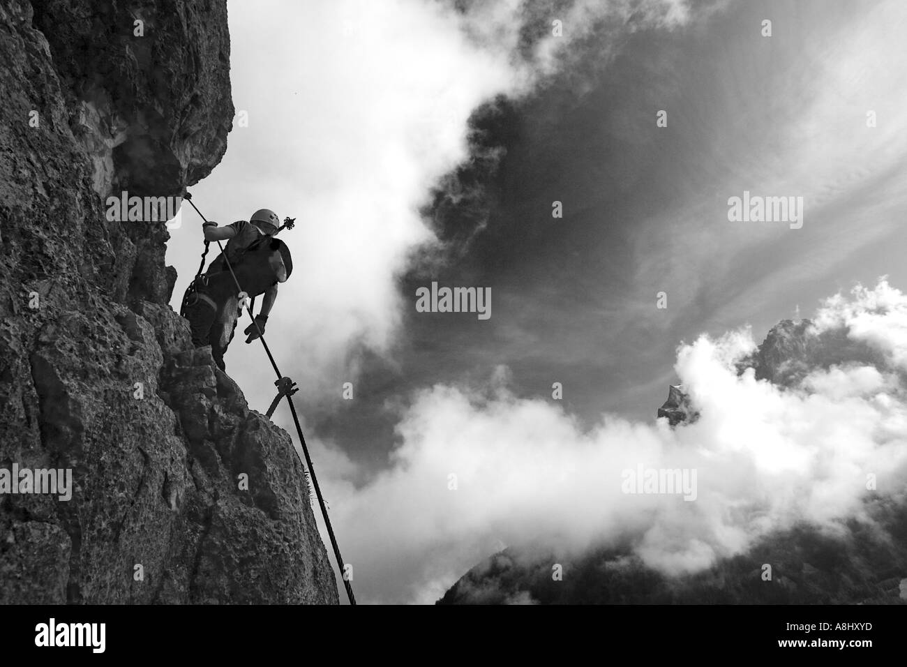 Climber at Seeben fixed rope route near Ehrwald in Austria opposite to the Zugspitz mountain Stock Photo