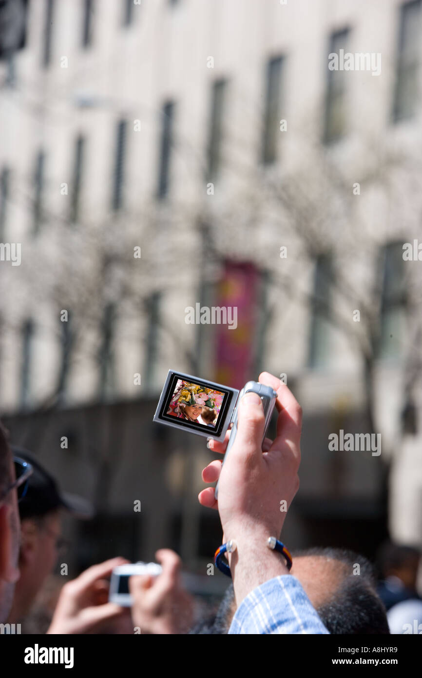 Tourist photographing w at NYC Easter Parade on 5th Avenue USA Stock Photo