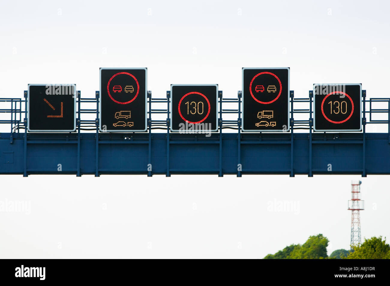 German autobahn electronic overhead gantry speed limit signs limiting overtaking for lorries and trailers in Germany Europe Stock Photo
