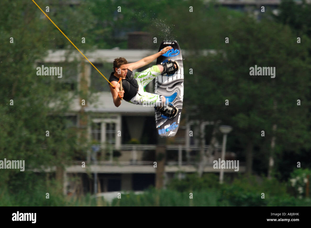 Wakeboarding boy with a lot of airtime 2006 with green tree background muscle Stock Photo Alamy