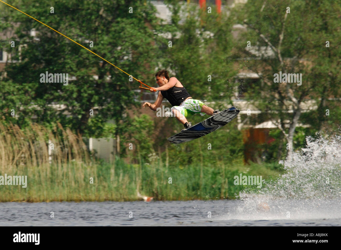 Wakeboarding boy with a lot of airtime 2006 with green tree background muscle Stock Photo Alamy