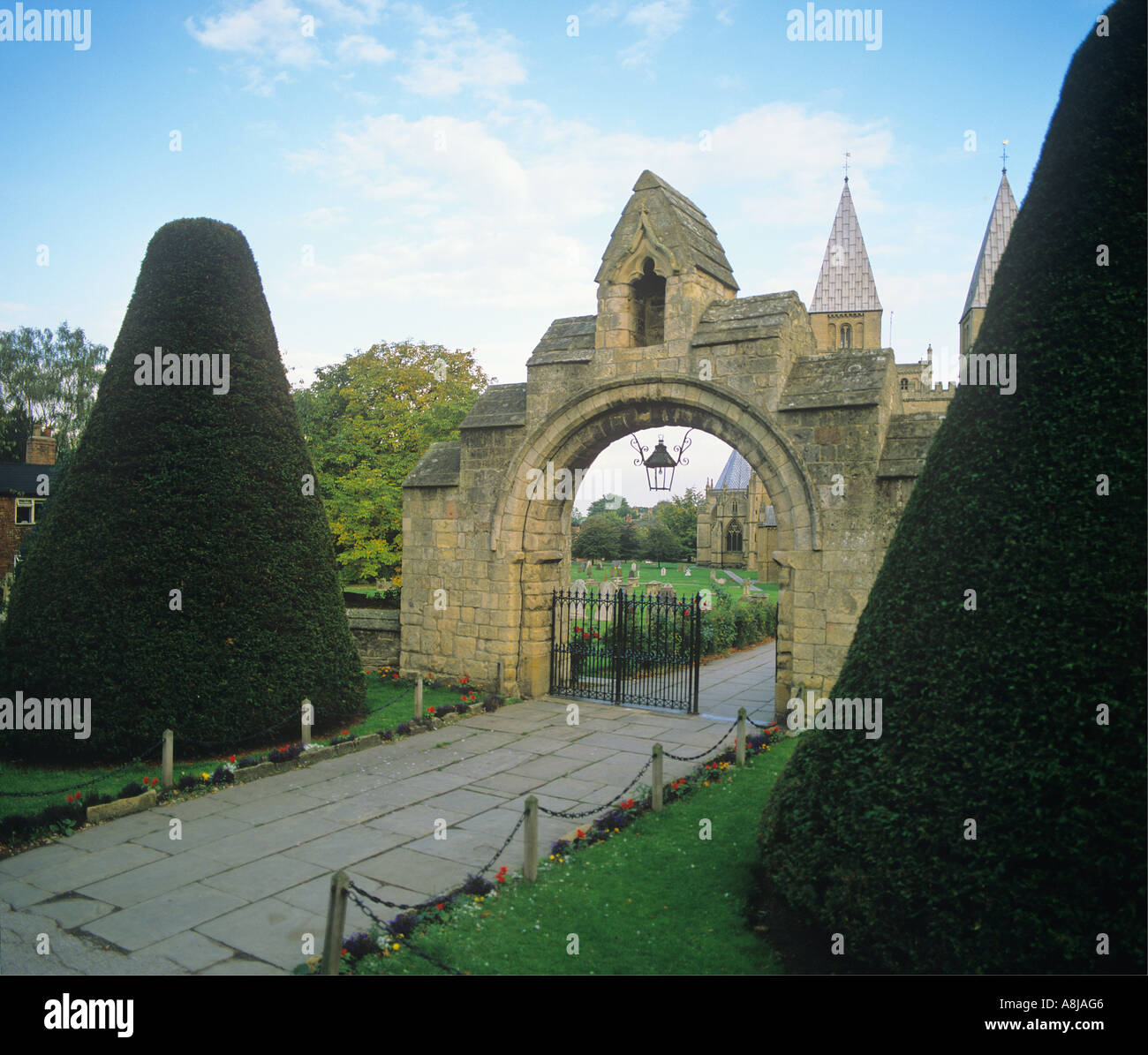 West Gate to Southwell Minster Nottinghamshire with large shaped Yew Trees Stock Photo