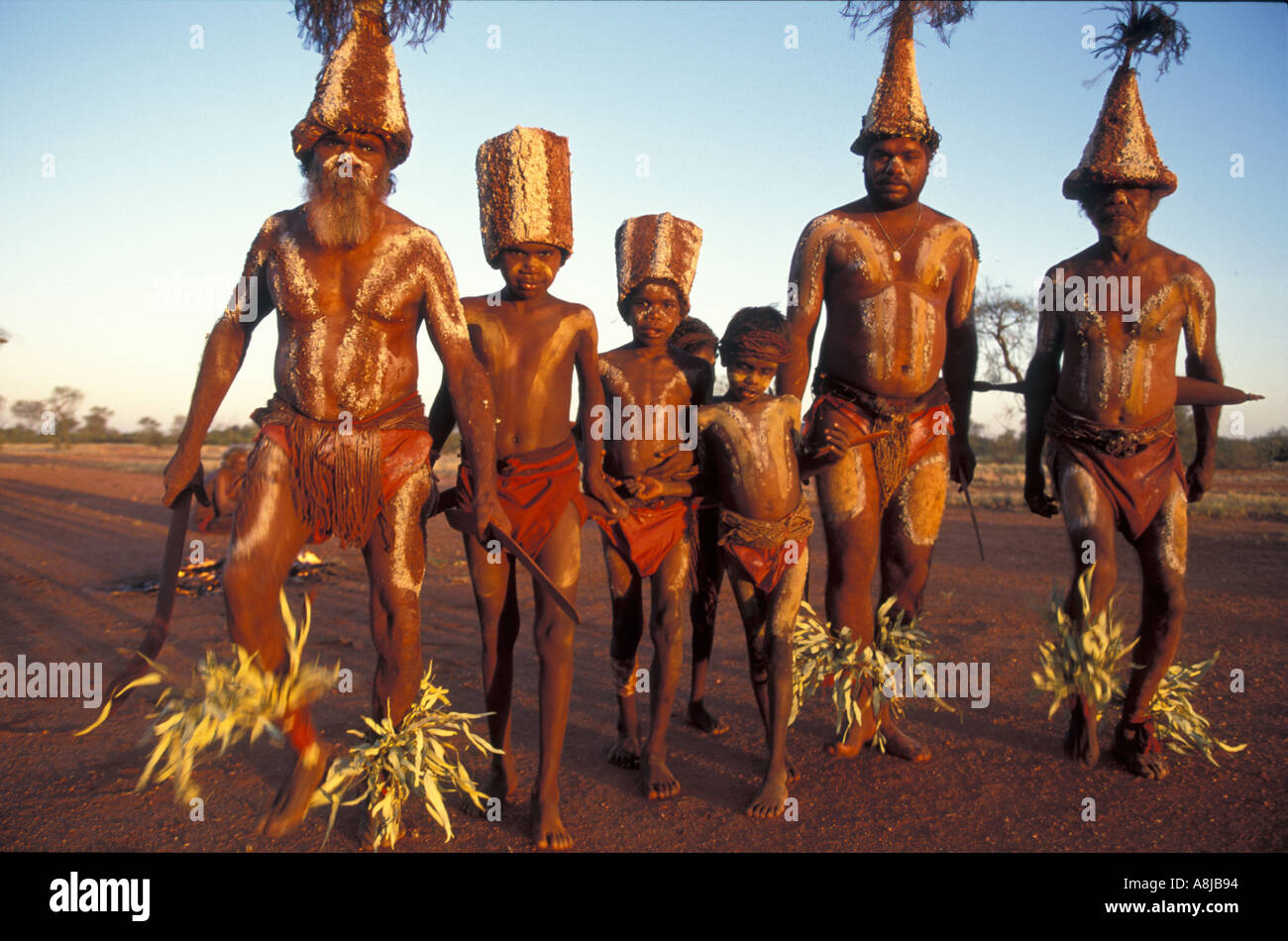 Aboriginal elders teaching boys traditional ceremony business Central Australia bodies painted with red ochre & totem decoration Stock Photo