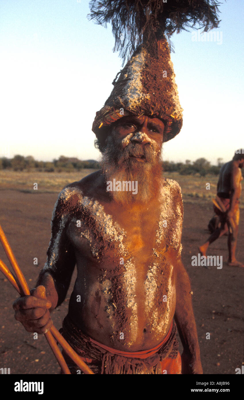 Aboriginal elder decorated for ceremony corroborree with body paint traditional headpiece and spears in desert Central Australia Stock Photo
