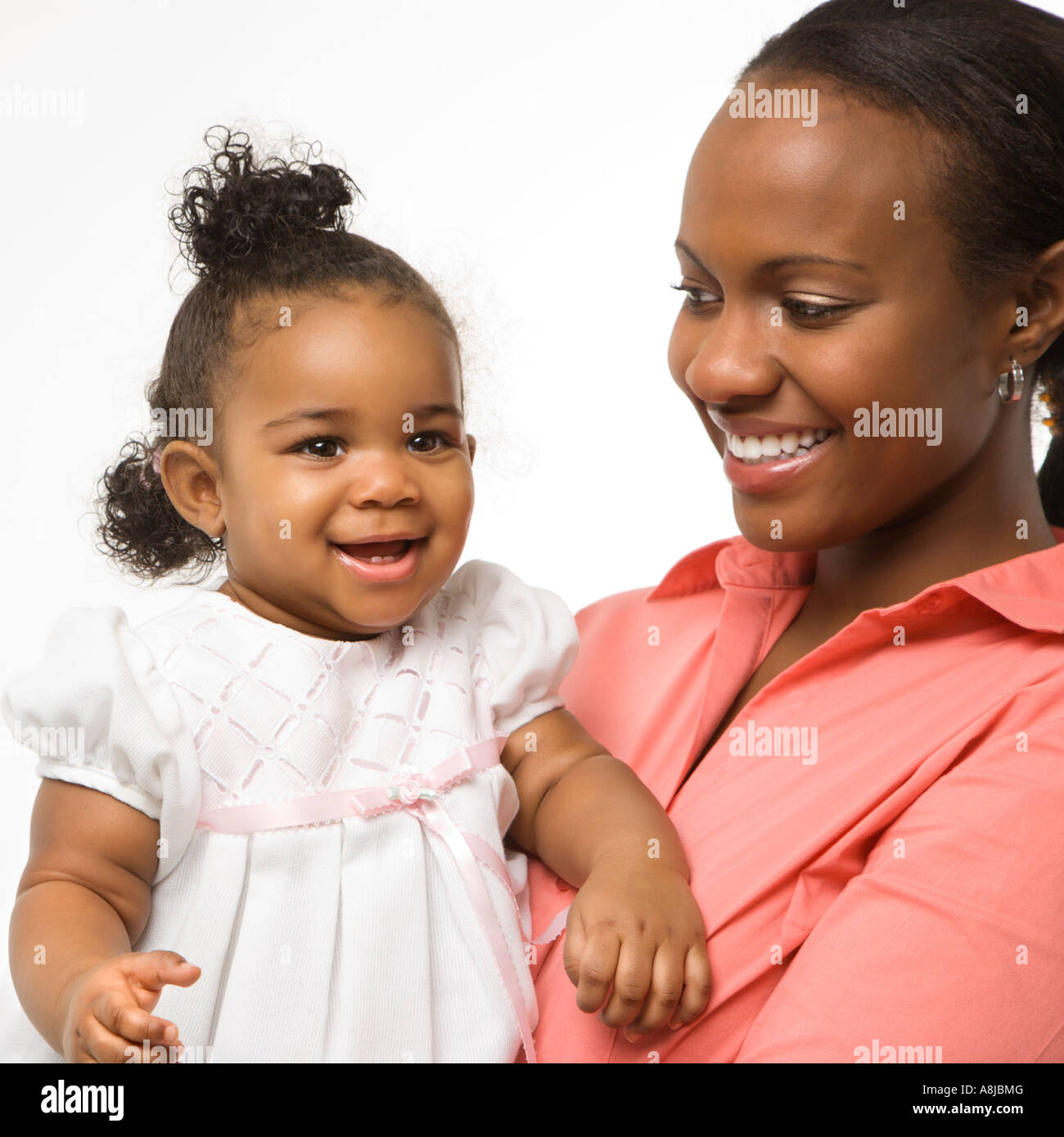 African American Woman Holding Infant Girl Standing Against White