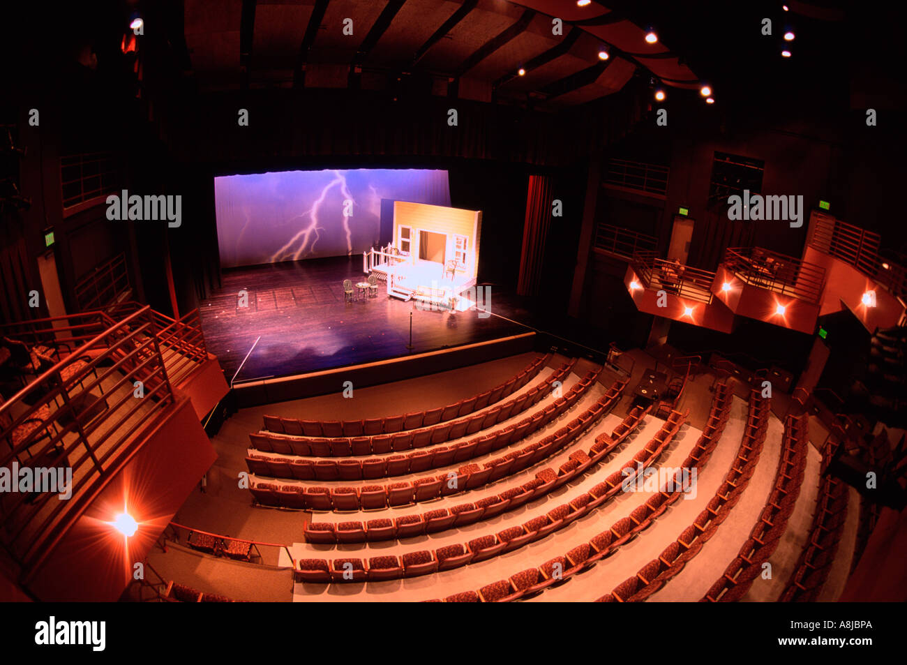 Interior of small theater with stage and set for play Stock Photo