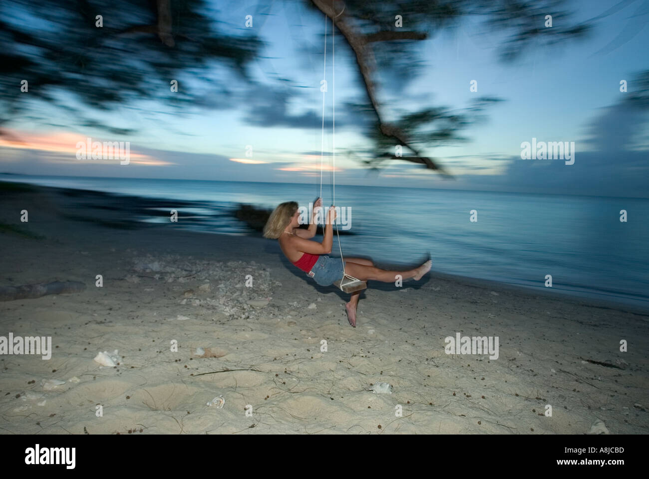 Woman at dusk on Bimini Bahamas Islands Stock Photo
