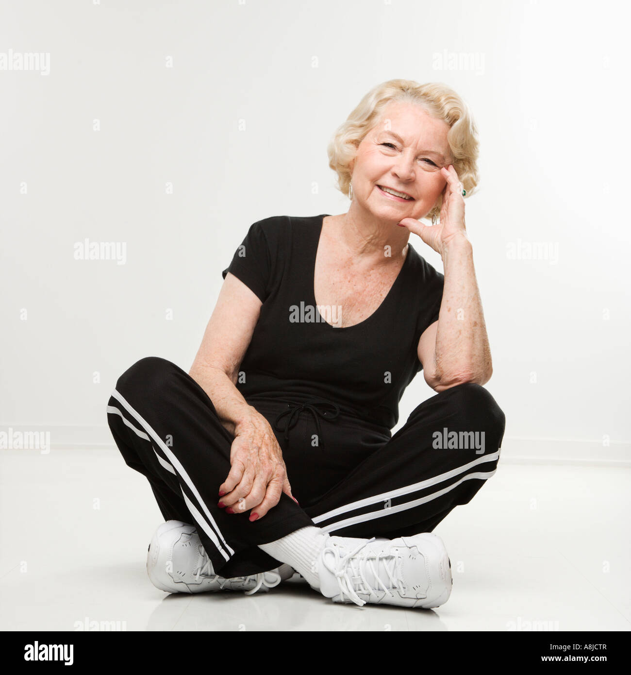 Mature woman sitting legs crossed hi-res stock photography and images ...