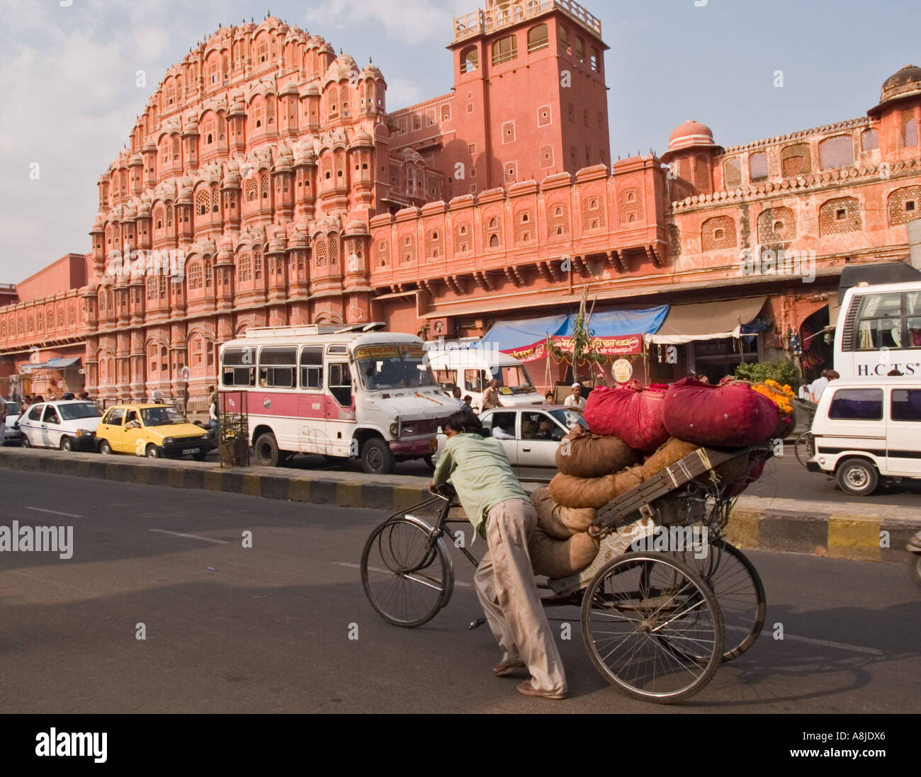 Hawa Mahal Bazaar with traffic passing Hawa Mahal Palace of Wind. Jaipur Rajasthan India Stock Photo