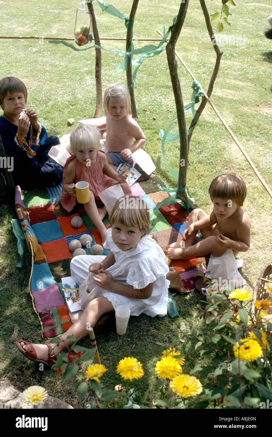 children having a picnic under the shade of a tree Stock Photo