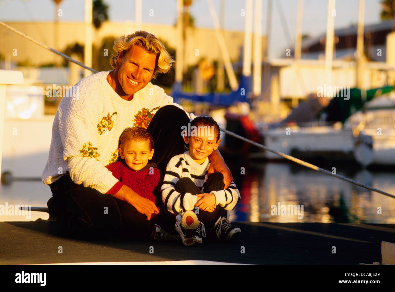 portrait of a father with his two sons in a marina Stock Photo - Alamy