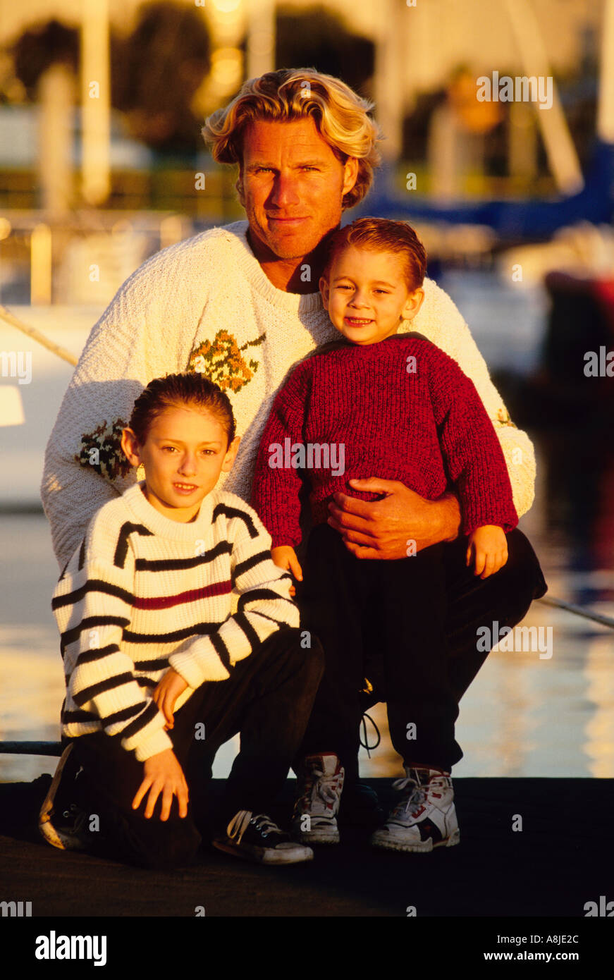 portrait of a father with his two sons in a marina Stock Photo - Alamy