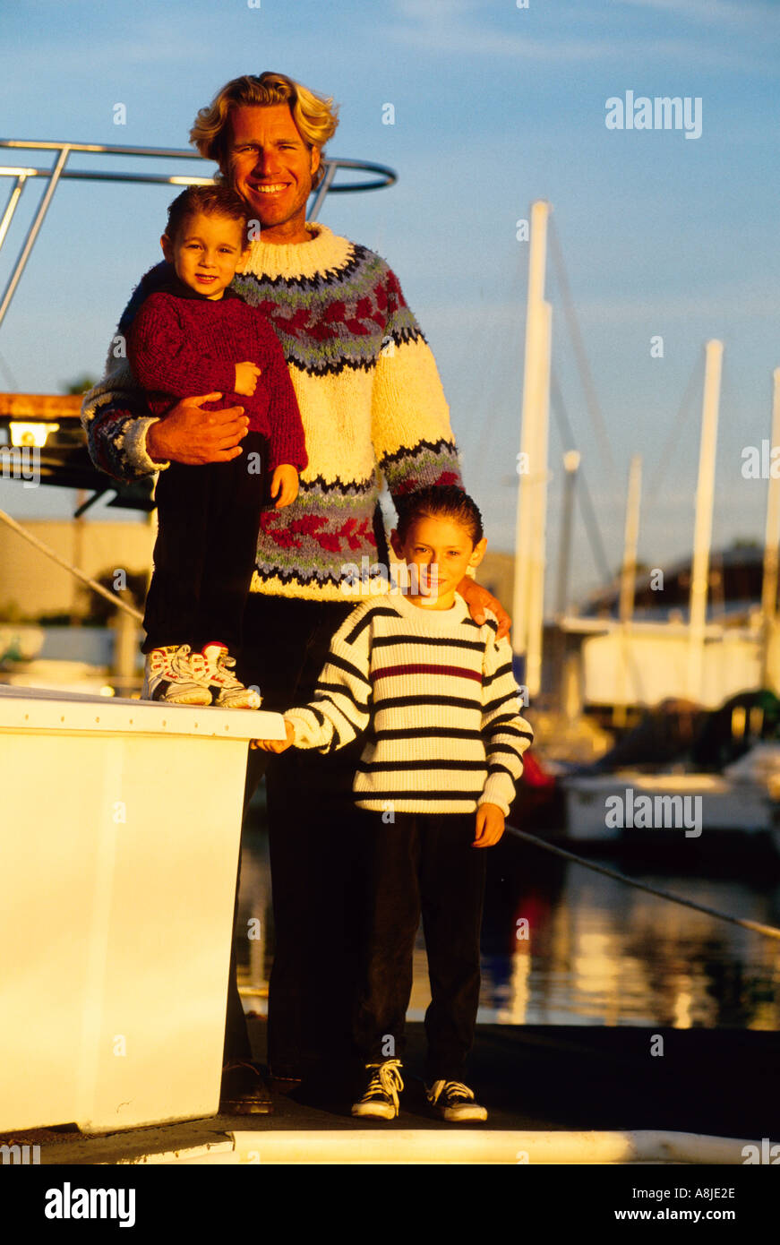 portrait of a father with his two sons in a marina Stock Photo - Alamy