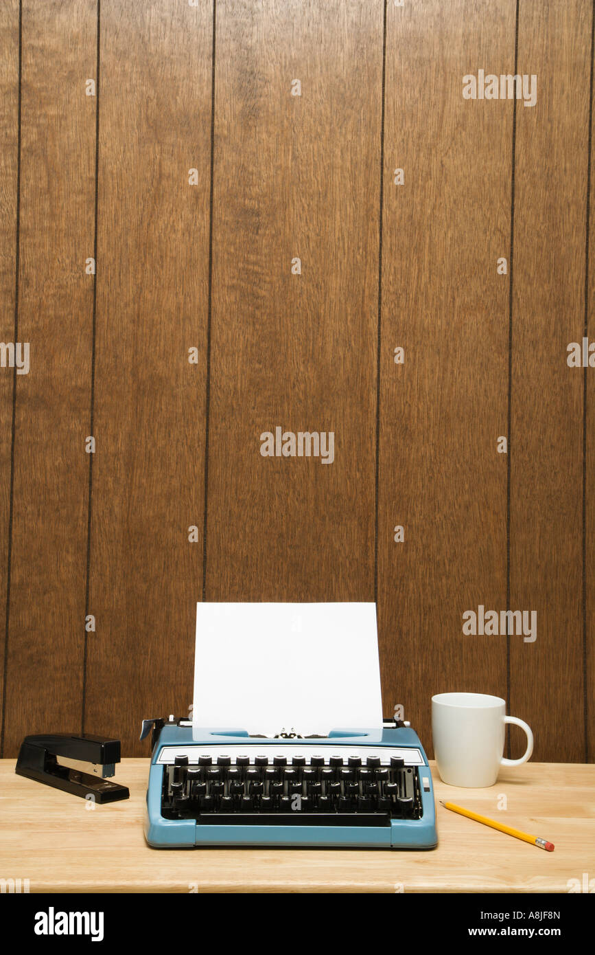 Vintage typewriter coffee cup pencil and stapler on desk Stock Photo ...