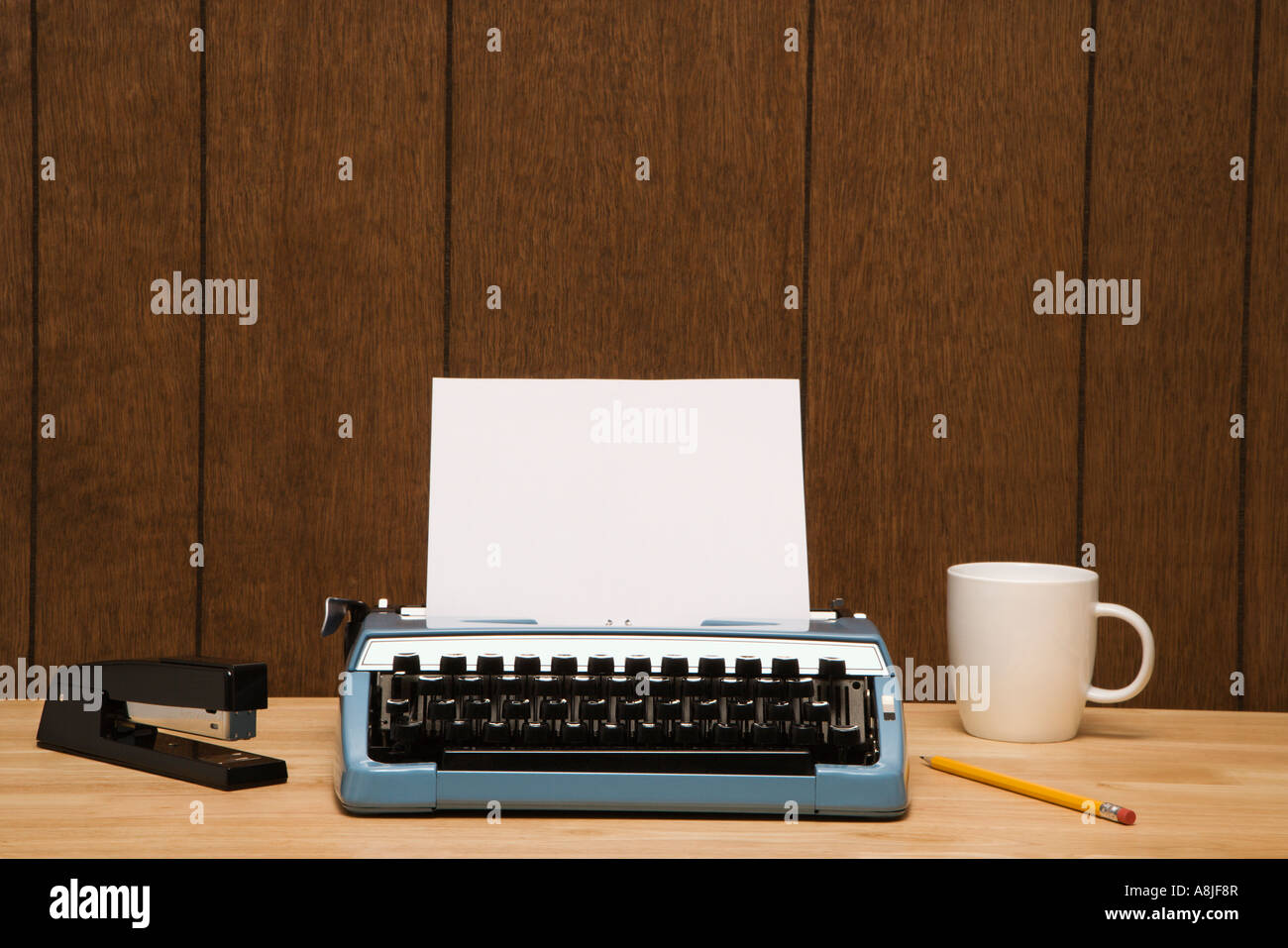Vintage typewriter coffee cup pencil and stapler on desk Stock Photo ...