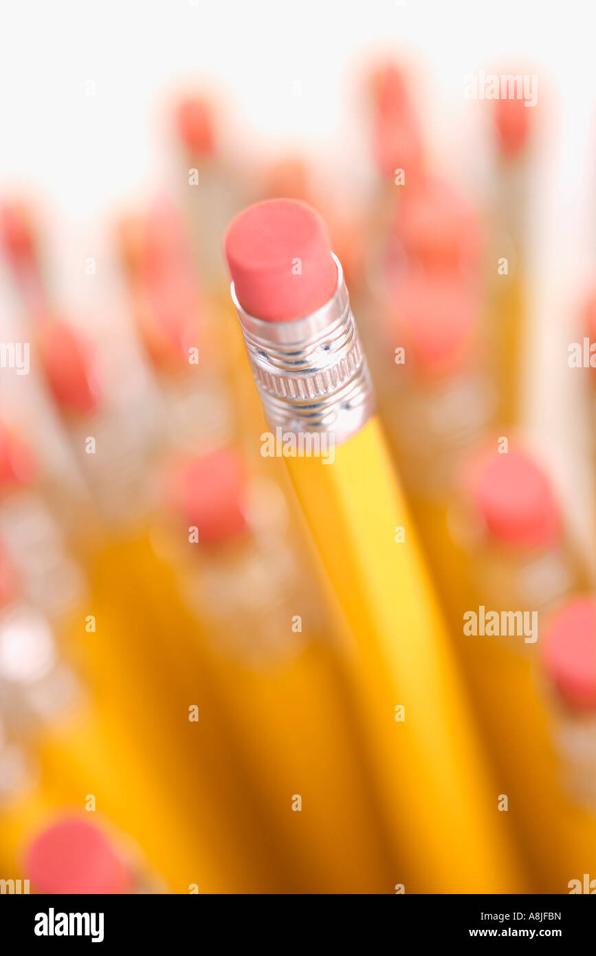Group of eraser ends of pencils with one standing out higher than the