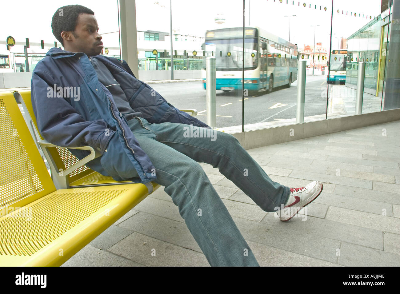 African negro male waiting for bus at bus station Stock Photo Alamy