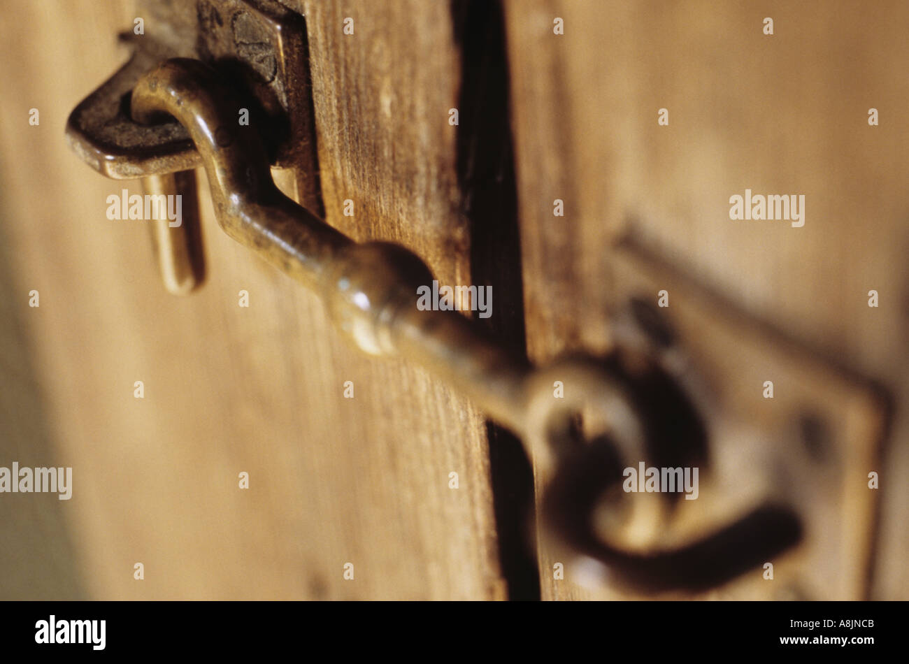 Close Up Of Old Latch Or Hook On Wooden Door Or Cabinet Stock