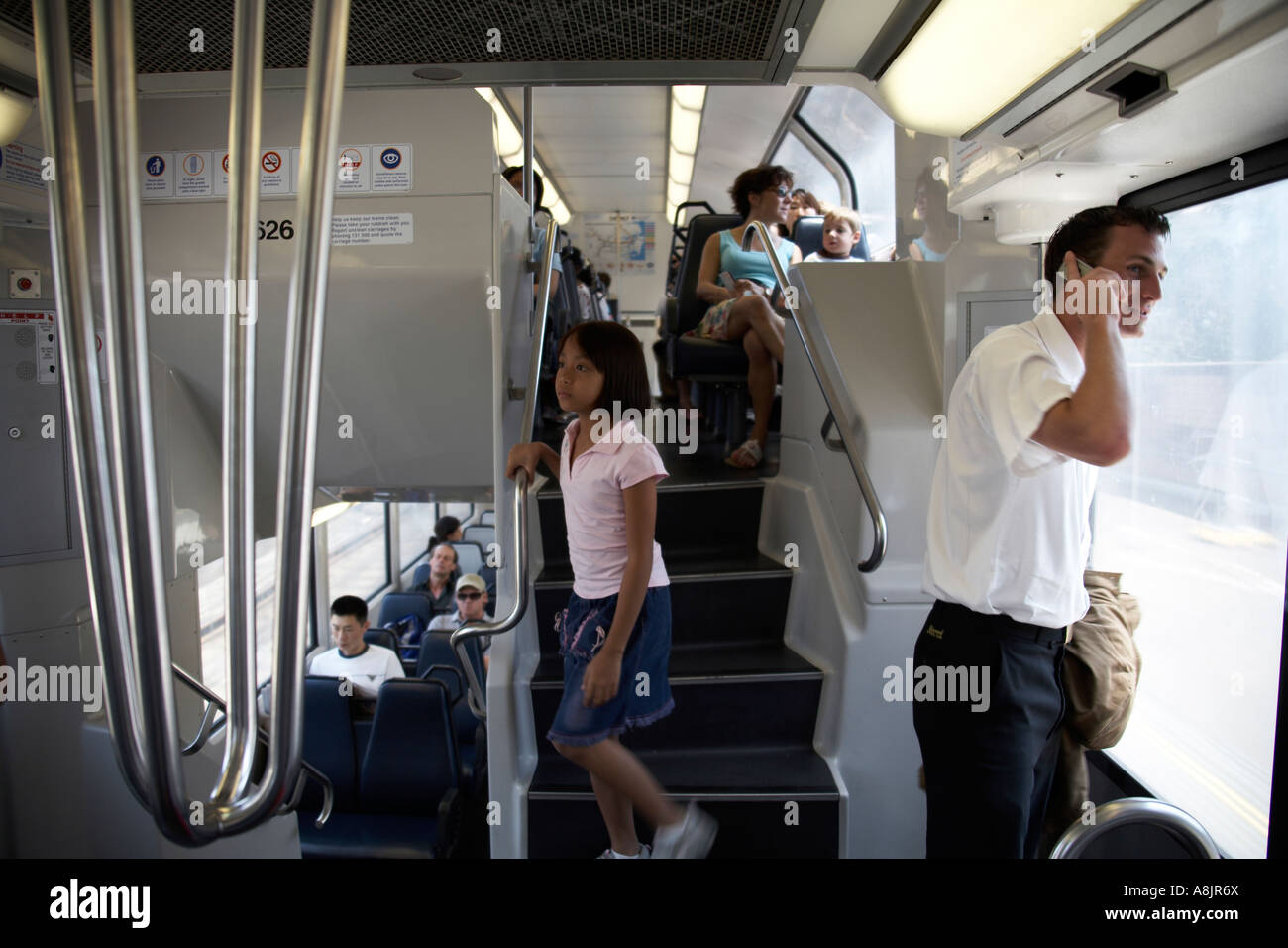Passengers on double decker suburban railway train carriage in Sydney New South Wales NSW