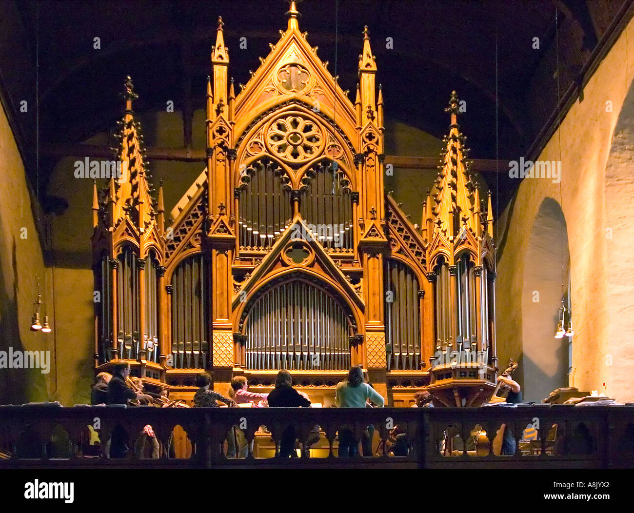 Baroque orchestra rehearsing Bach cantata in organ and choir loft of Domkirken Cathedral Bergen Norway Stock Photo