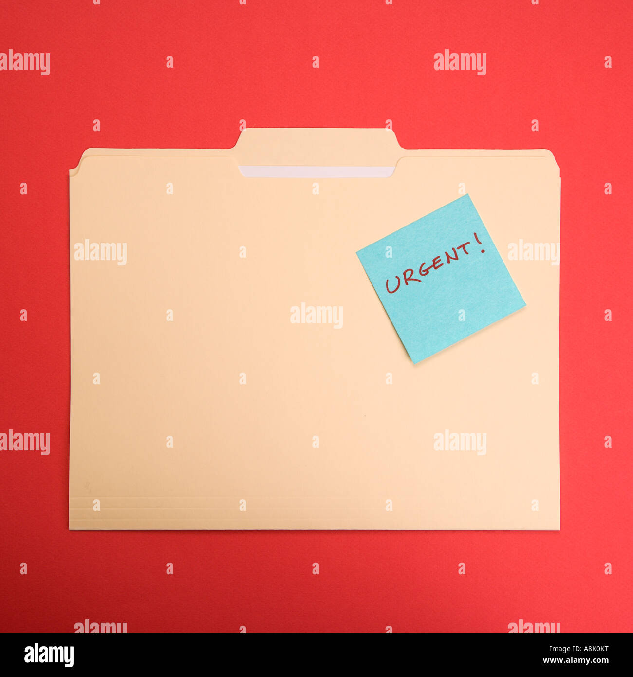 Folder with a sticky note attached reading urgent on a red background ...