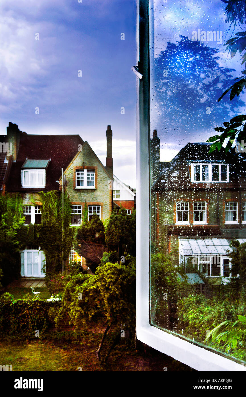 Open window looking out to back garden and Victorian houses London