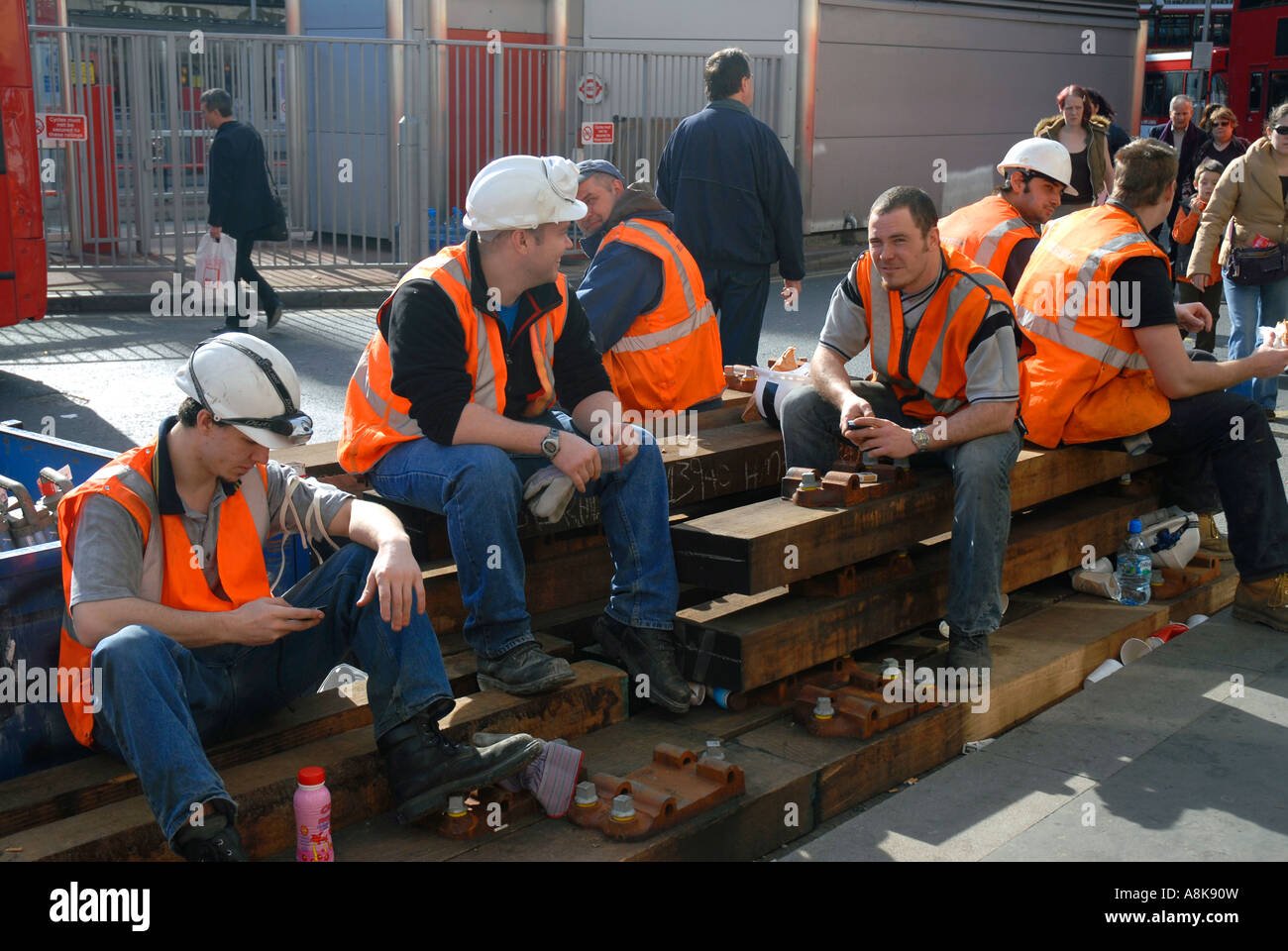 Group of construction workers eating sandwiches on breaktime Stock