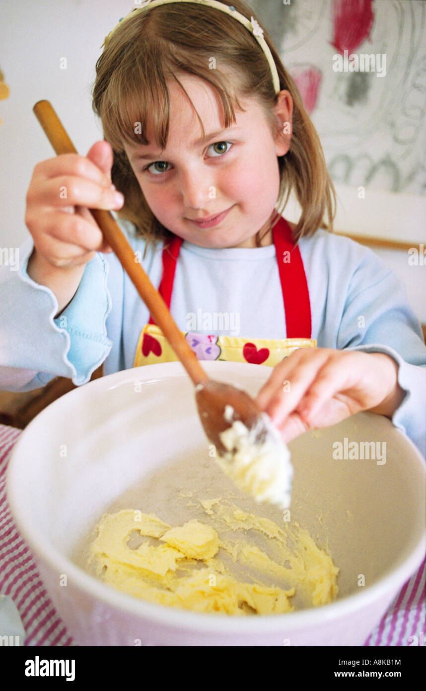 A young girl making a cake Stock Photo