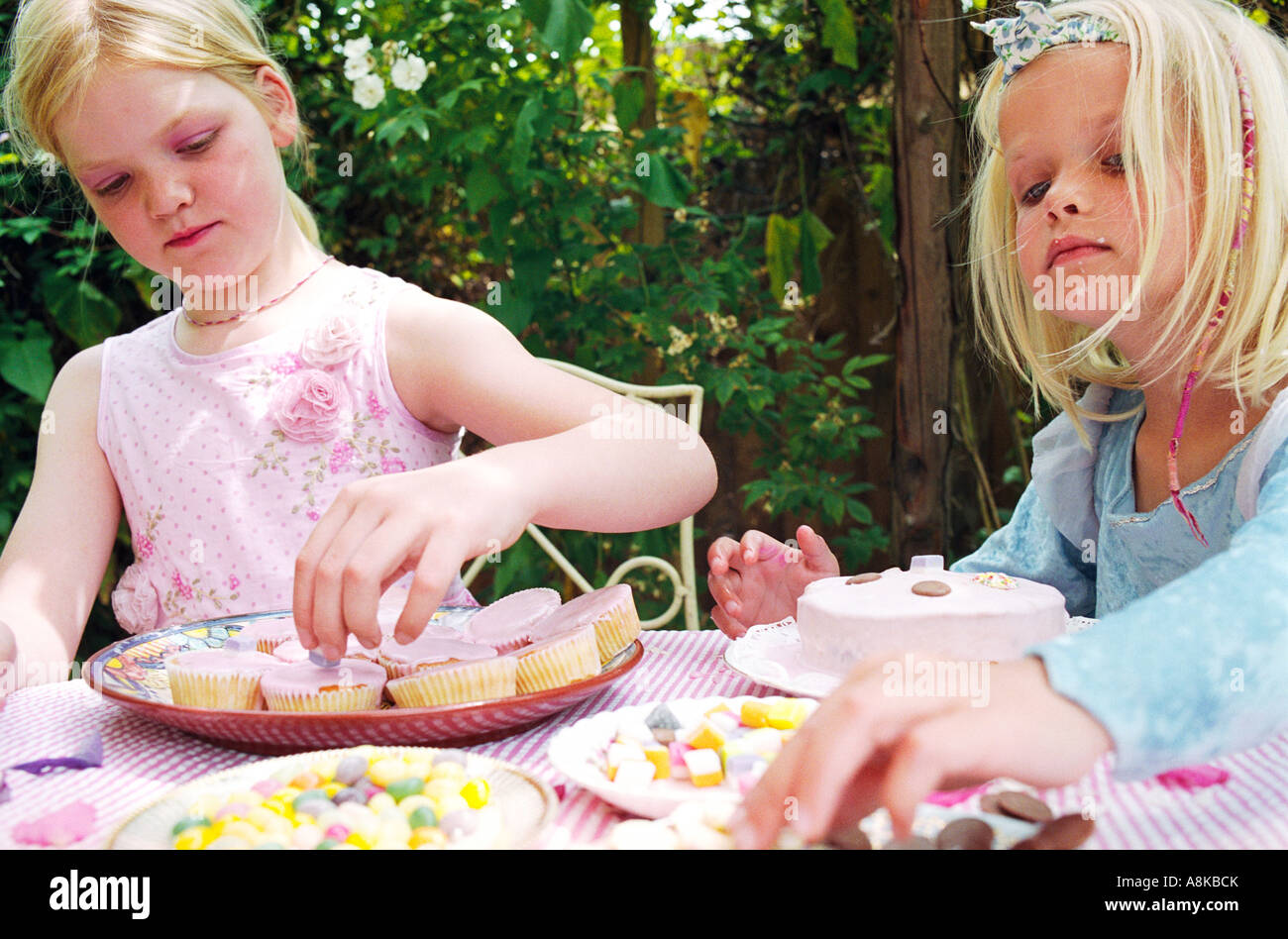 Children decorating cakes Stock Photo