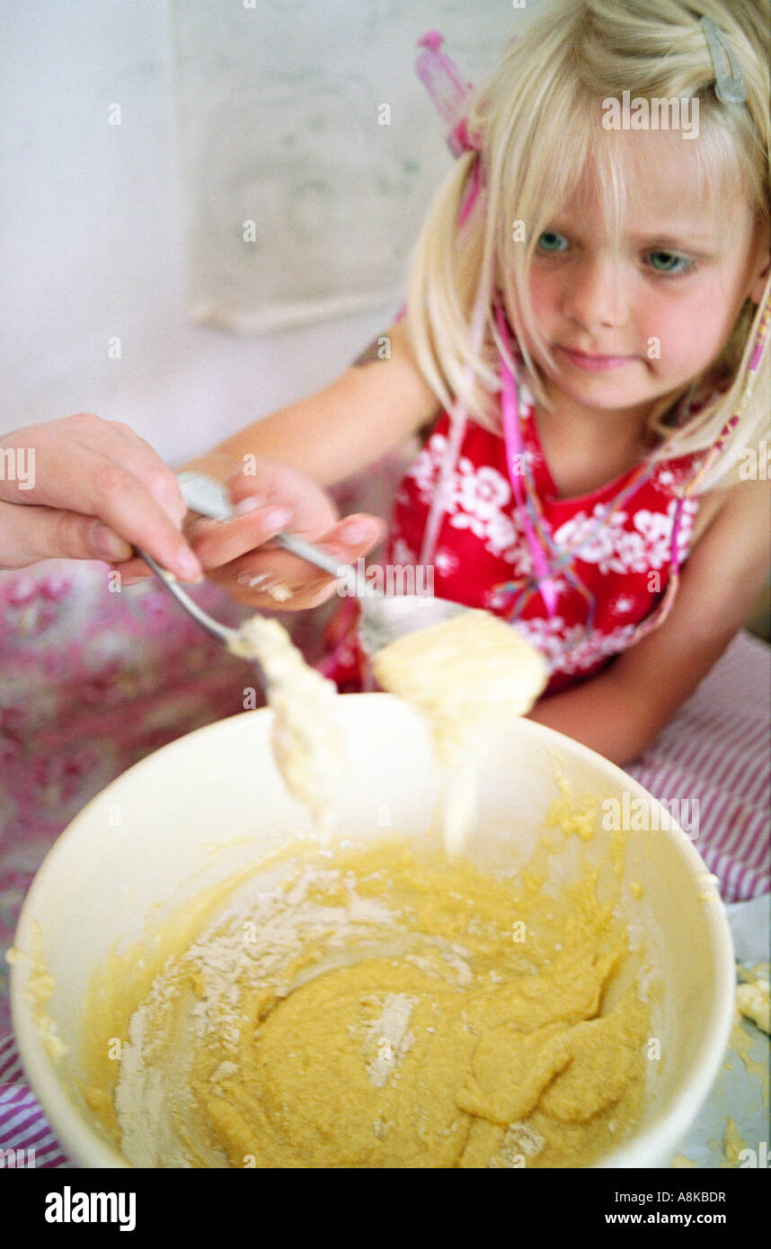 A young girl making cake mixture Stock Photo