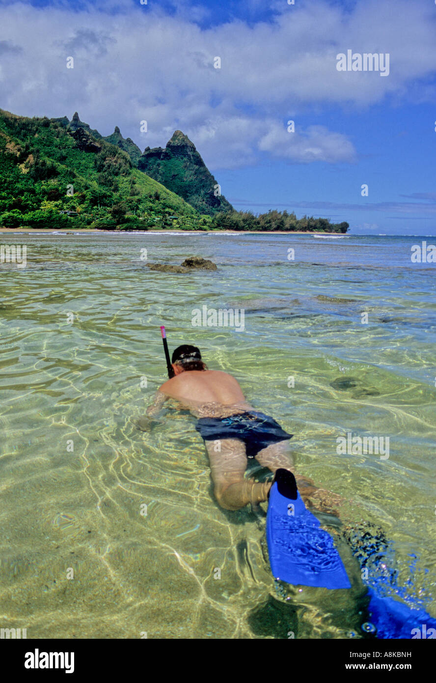 Snorkeler off Tunnels Beach on Kauai with "Bali Hai" (Mt. Makana) in