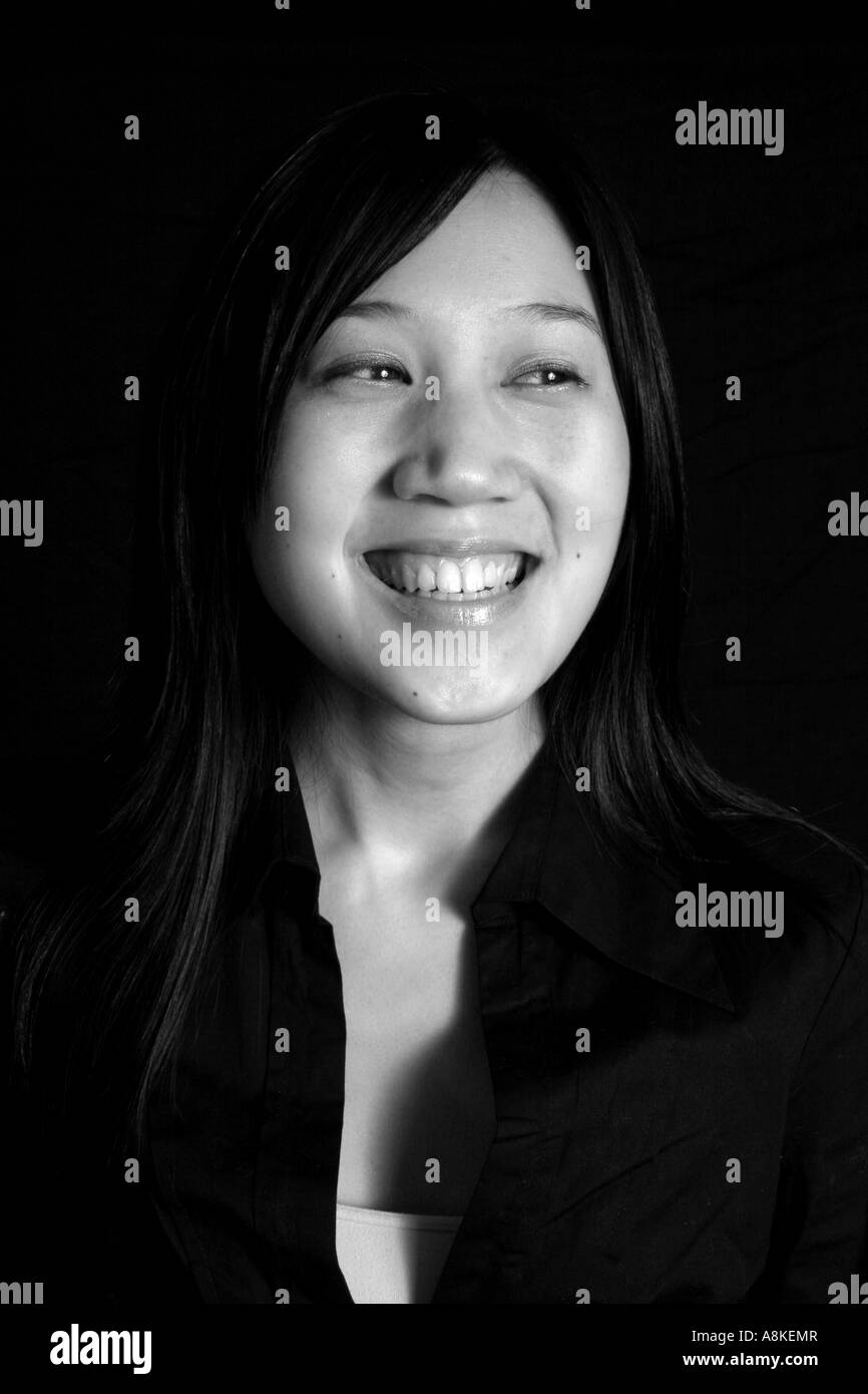 black and white photograph of a happy, smiling oriental woman Stock Photo
