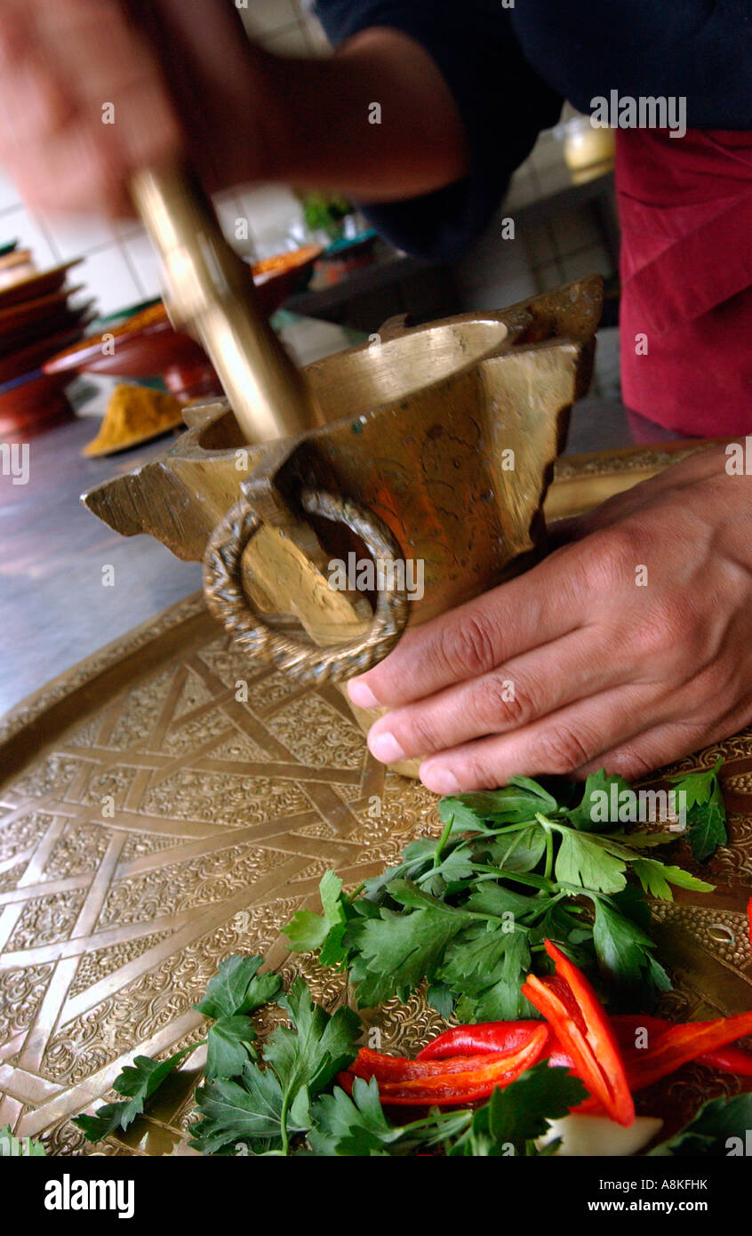 Grinding herbs and spices in a brass pestle and mortar Stock Photo Alamy