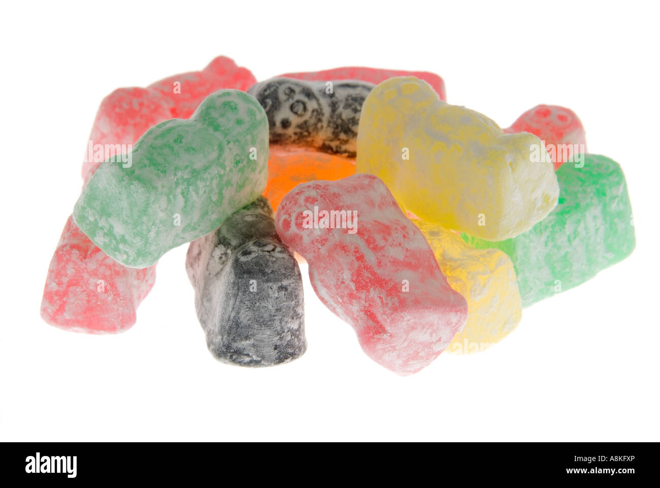 Horizontal close up of a pile of powdery multi coloured jelly babies on a white background Stock Photo