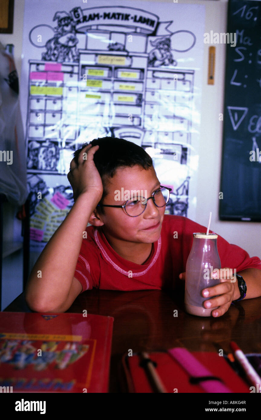 Child drinking a bottle of milk during a mid-morning break at school in Solingen, North Rhine-Westphalia, Germany. Stock Photo