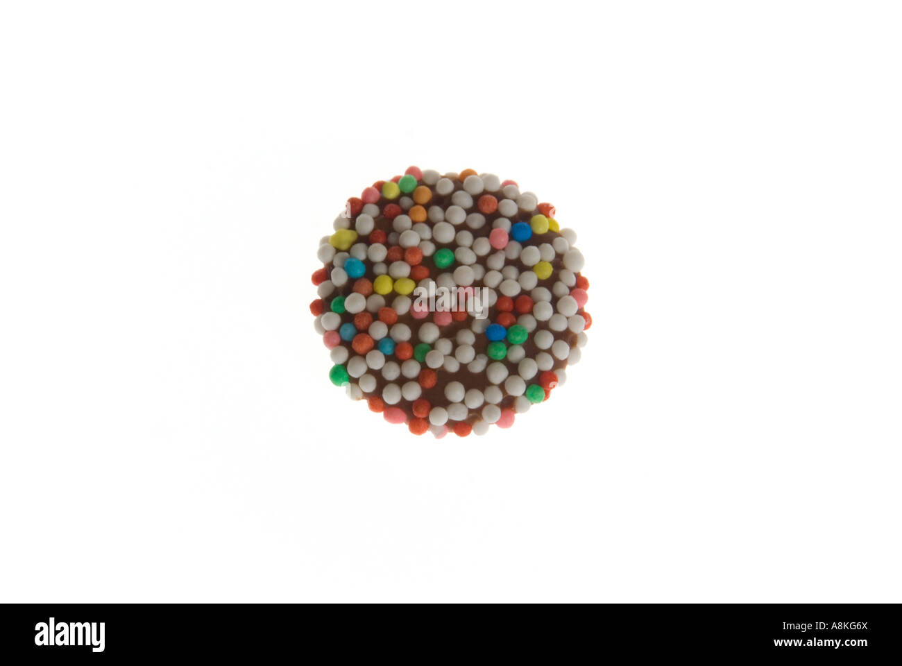 Horizontal close up of one milk chocolate button on a white background. Stock Photo