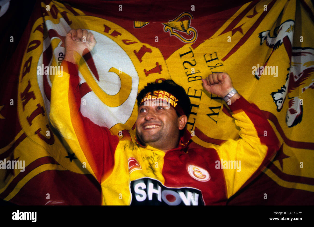 A Galatasaray football fan celebrates a goal against local rivals Fenerbahce in Istanbul, Turkey. Stock Photo
