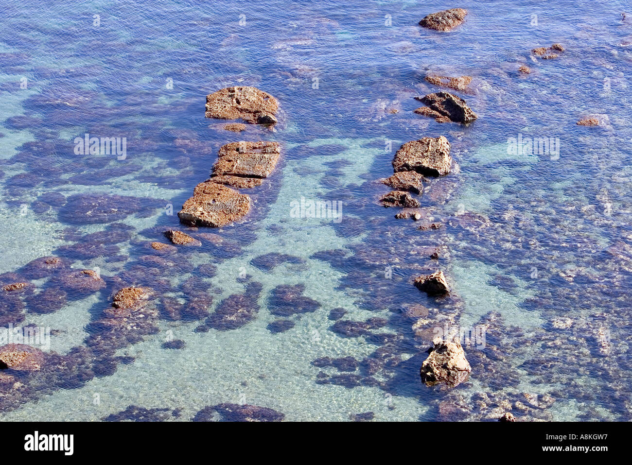 Strange beautiful rock formations in shallow sea on a beach in Spain ...