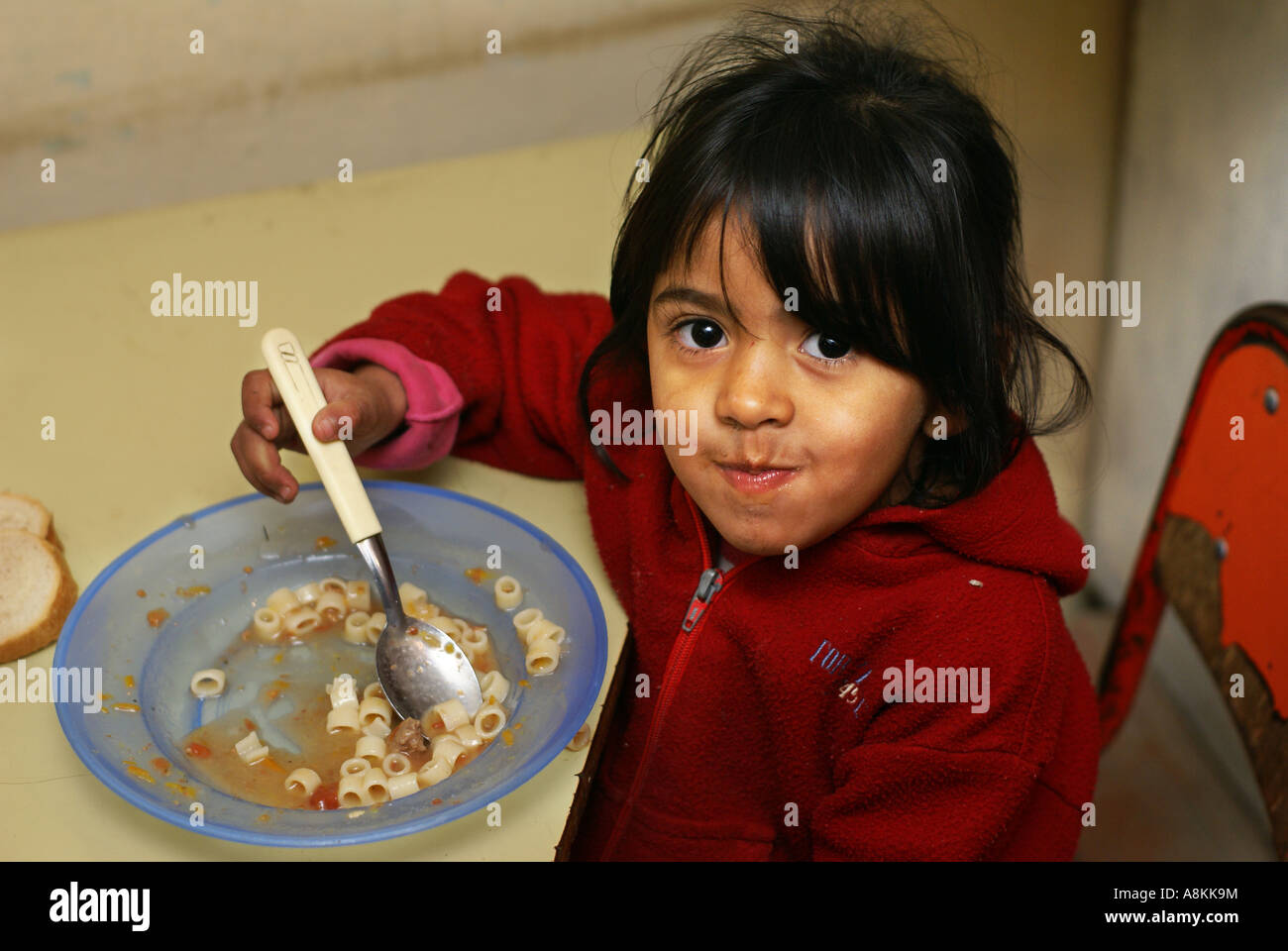 Poor girl in a soup kitchen, Cordoba, Argentine Stock Photo