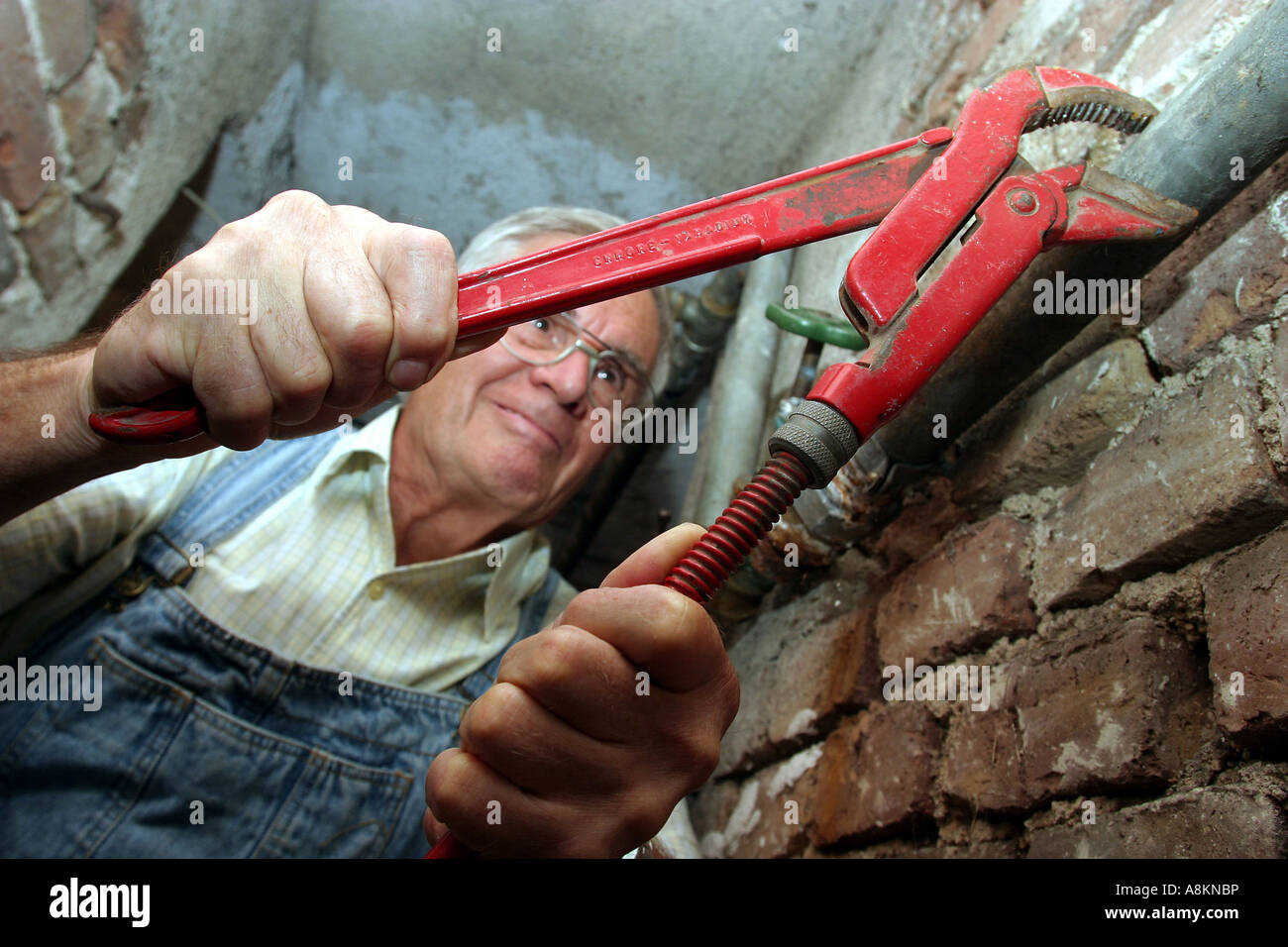 Plumber fixes a burst pipe Stock Photo Alamy