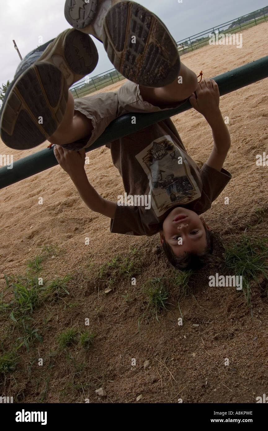 Boy hanging upside down Stock Photo Alamy