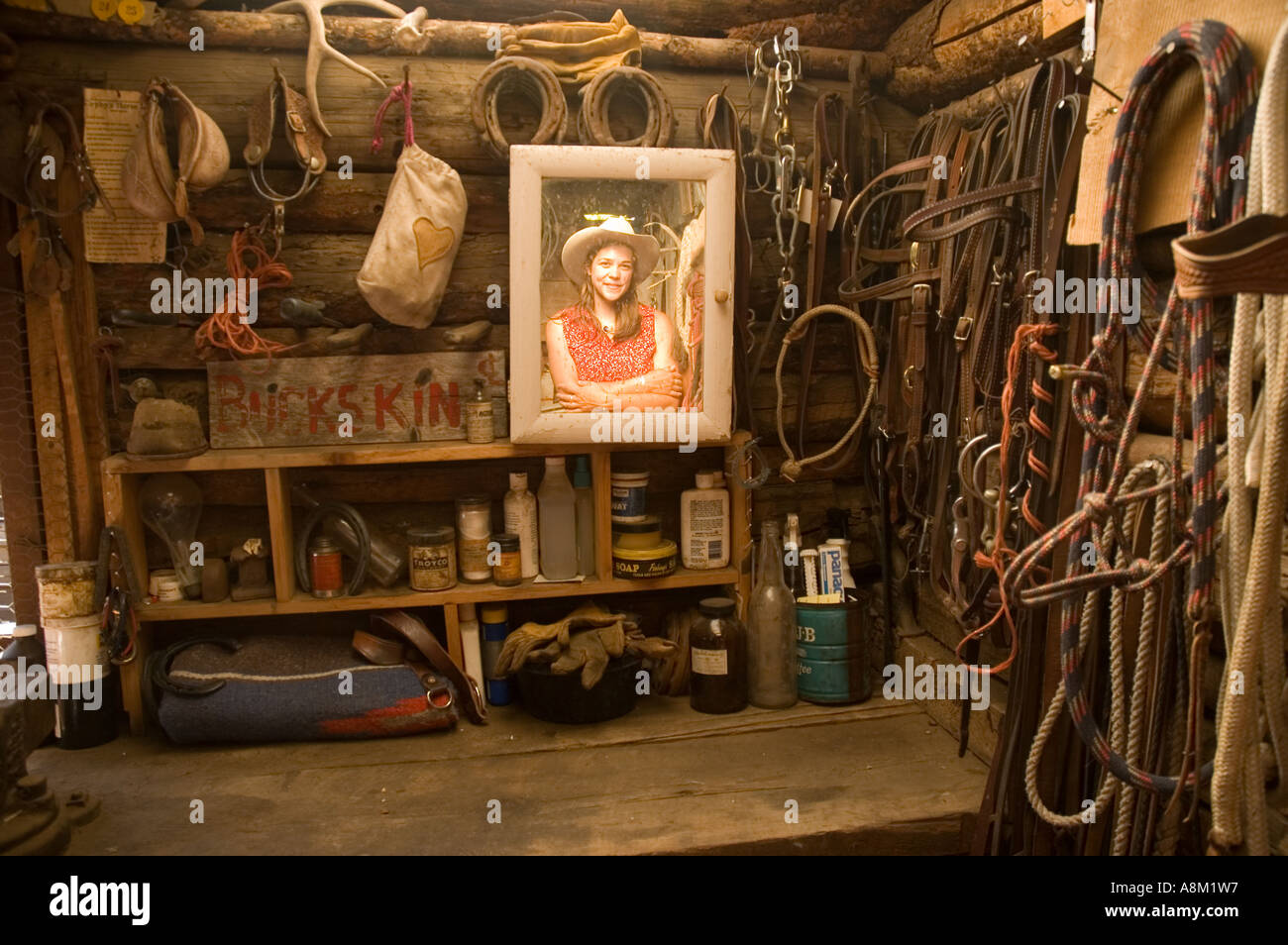 IDAHO INDIAN CREEK GUEST RANCH Cowgirl looking in framed wooden mirror