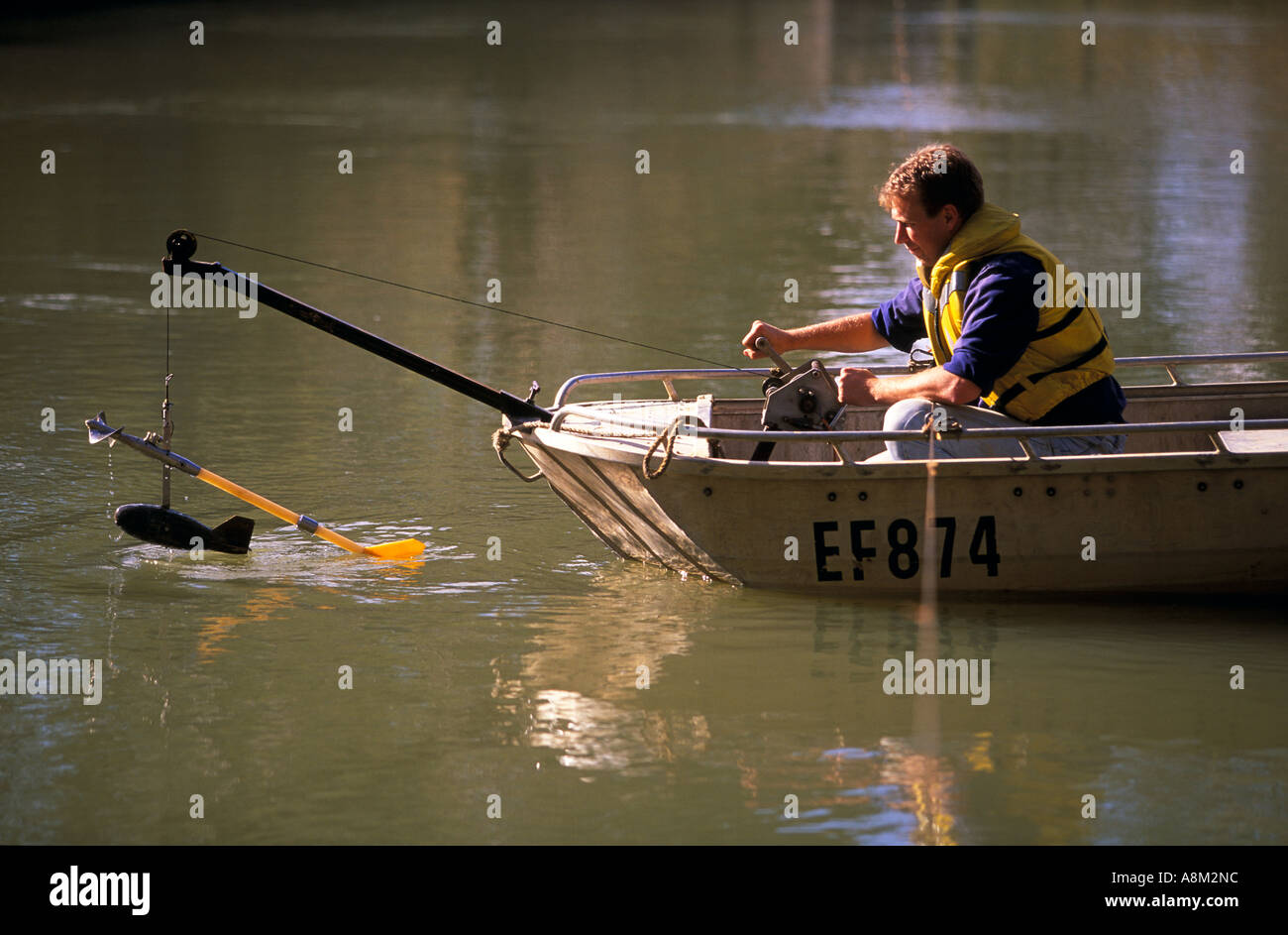 Hydrologist measuring flow rate in Murray River Barmah Victoria Australia Horizontal Stock Photo