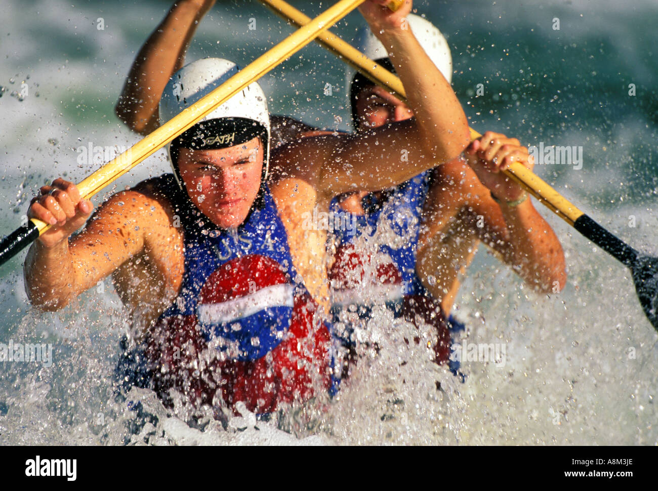 USA IDAHO Men in tandem kayak navigating through churning whitewater