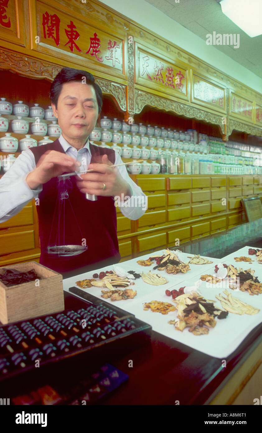 A traditional Chinese herbalist weighing out ingredients Taipei Taiwan Stock Photo
