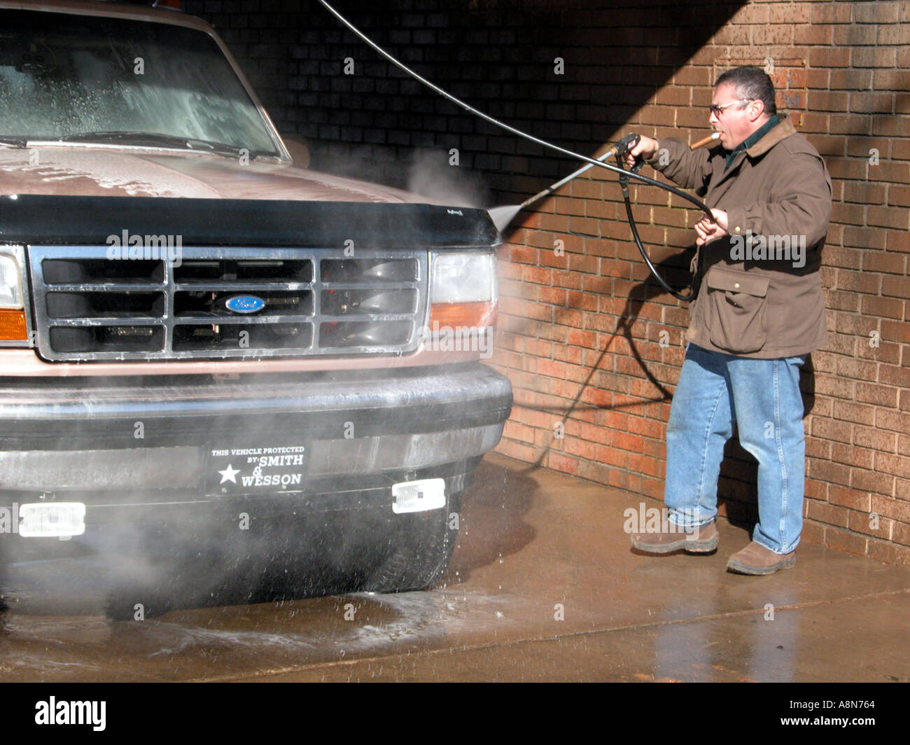 Man washing his suv truck in car wash Stock Photo - Alamy