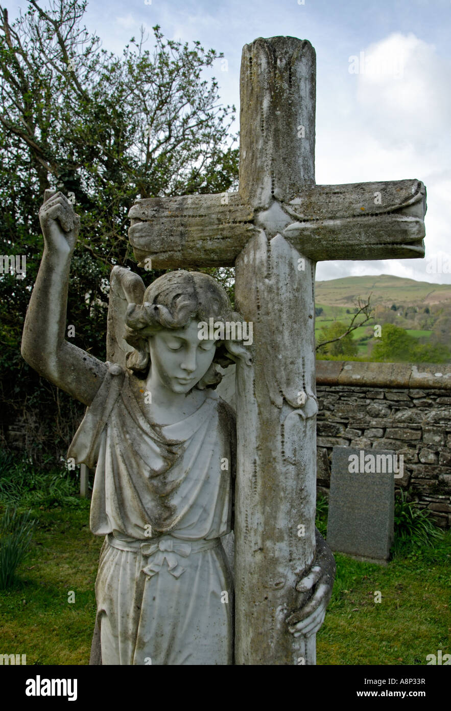 Angel and cross gravestone, Church of Saint Cuthbert, Lorton. Lake Dsitrict National Park, Cumbria, England, U.K., Europe. Stock Photo