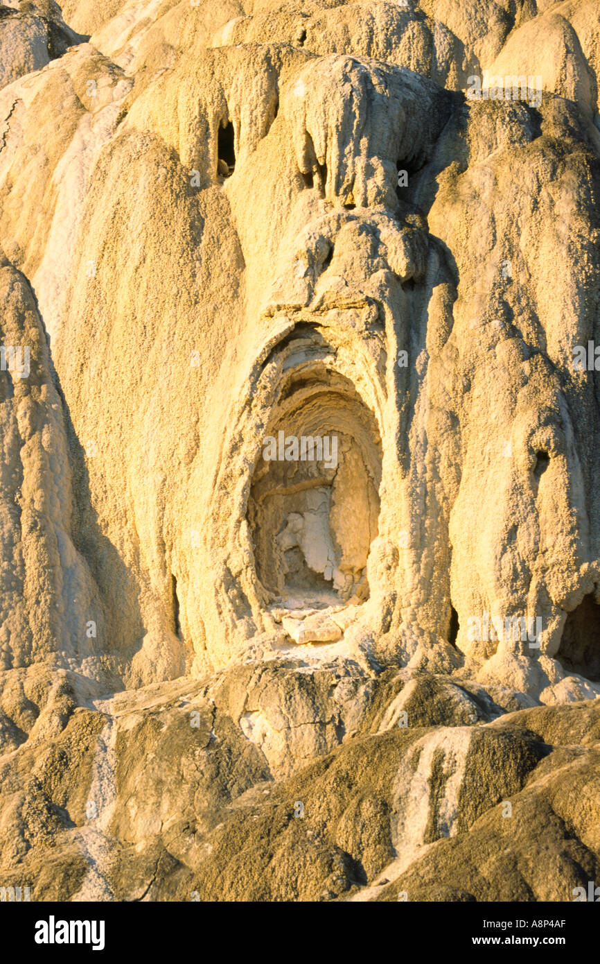 Flow of Travertine at Mammoth Hot Springs caught in morning light and resembles a face distorted by a horrific scream Stock Photo