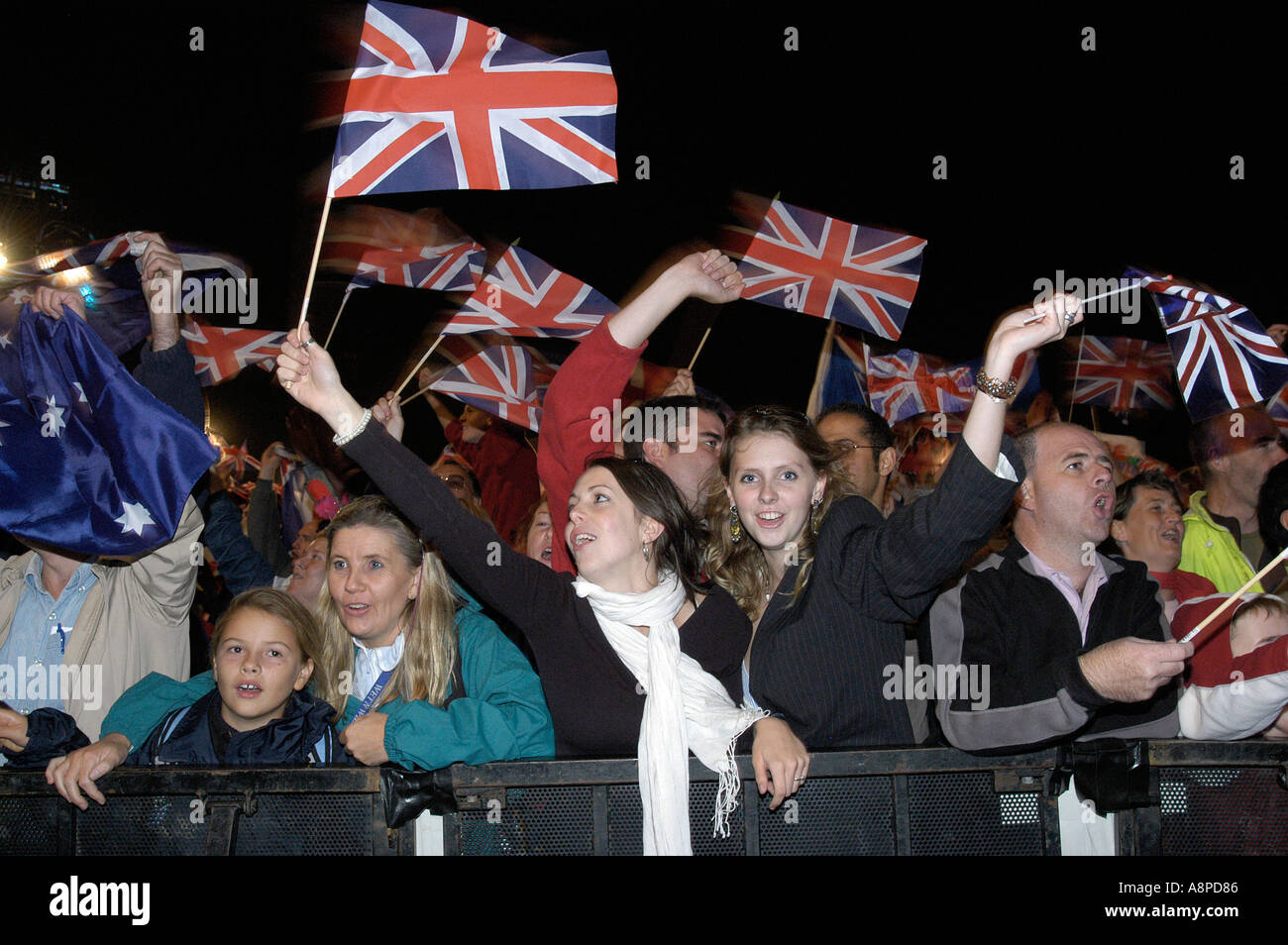 Patriotic fans at an outdoor prom in Hyde Park London waving national flags Stock Photo